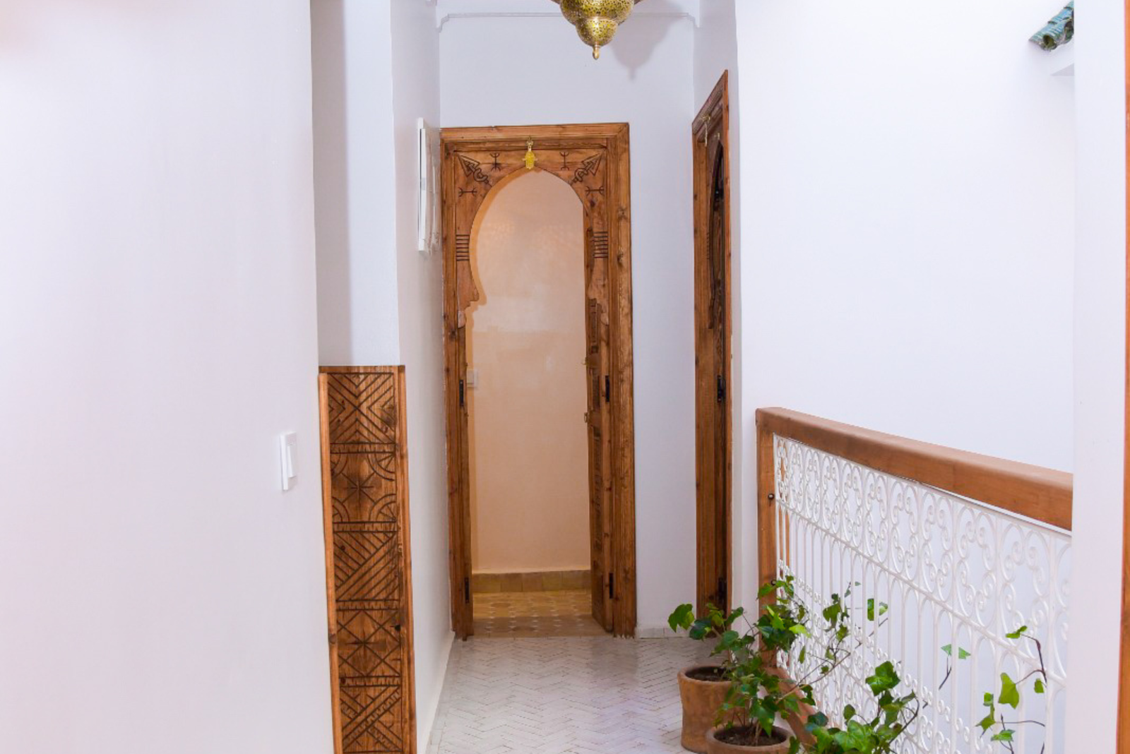 Warmly lit traditional corridor at Riad Nour Boutique